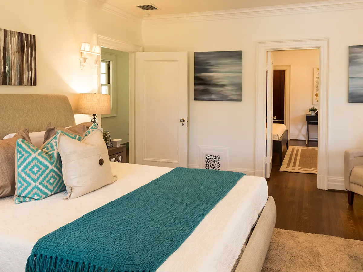 A bedroom with wood and carpet floor