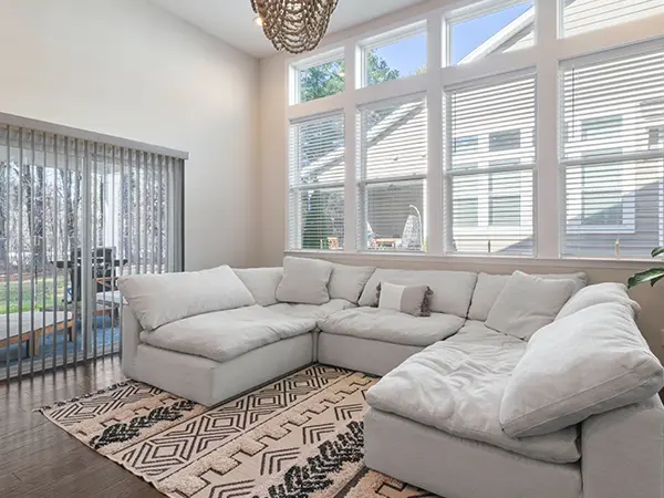 A living space with a large white couch on a carpet