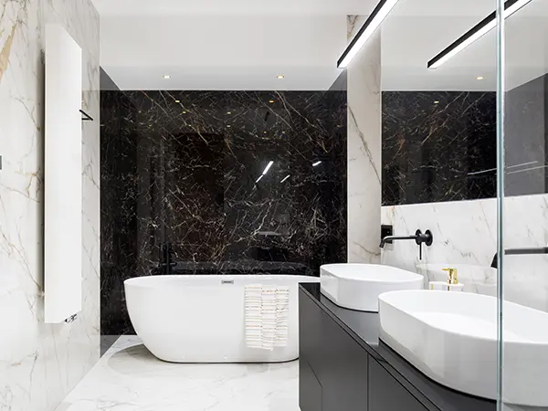 An upscale bathroom with a freestanding tub and tile floors and walls