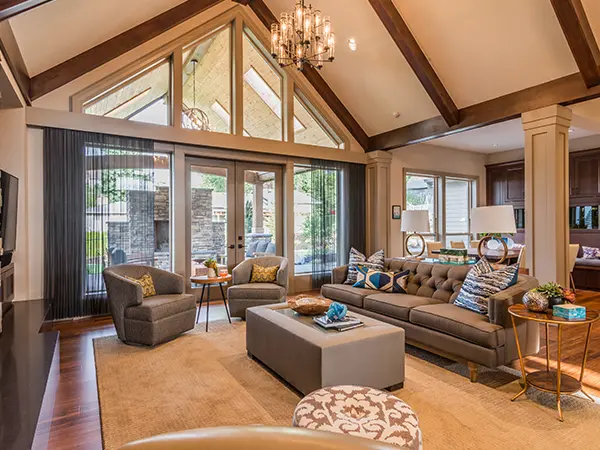 A large living space with gray couches and chairs