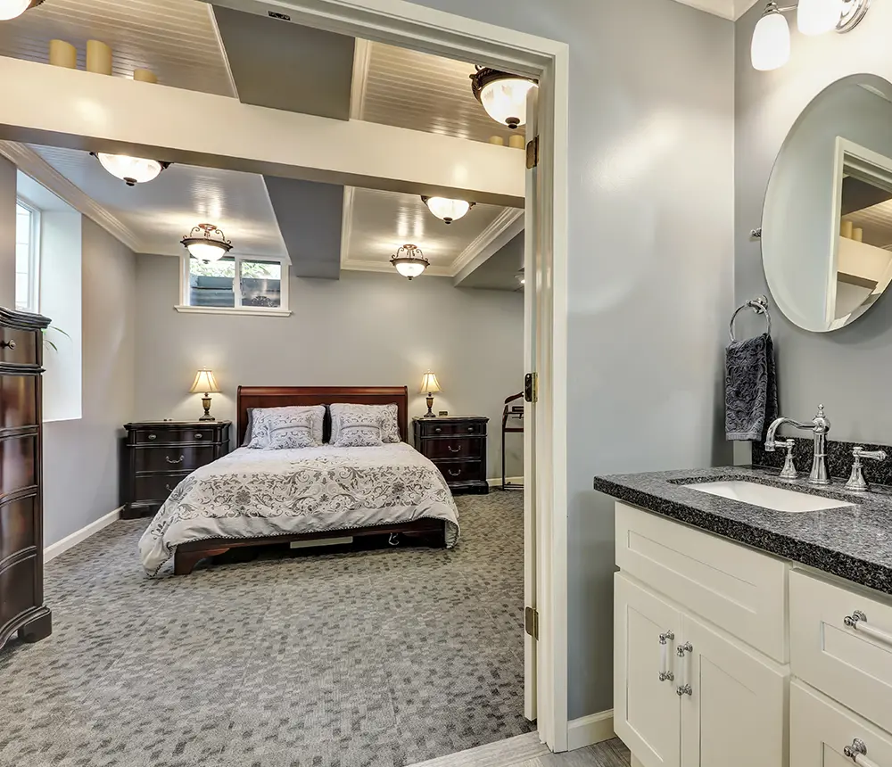 A bedroom with hardwood night stands and carpet floor