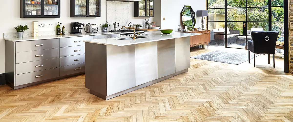 Wood kitchen floor with island and white cabinets