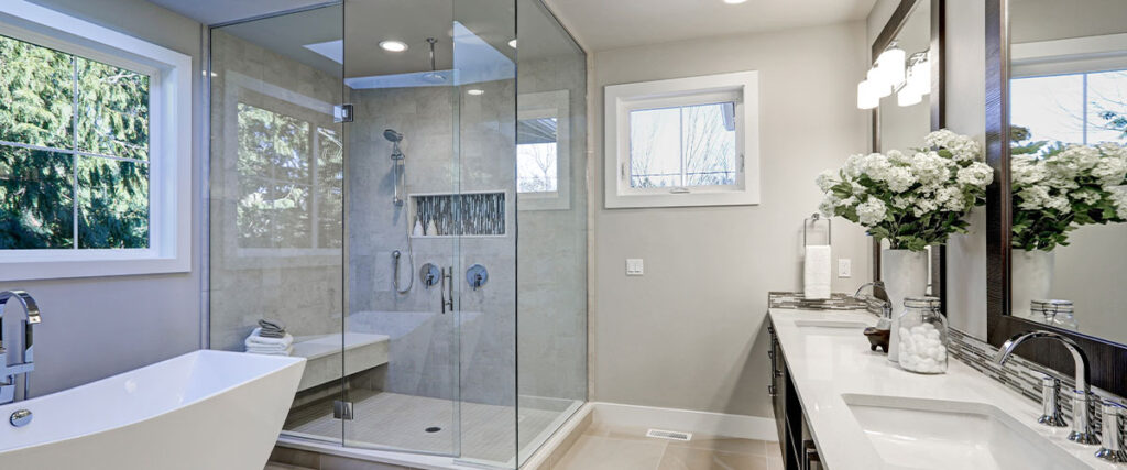 Spacious bathroom in gray tones with tub and shower