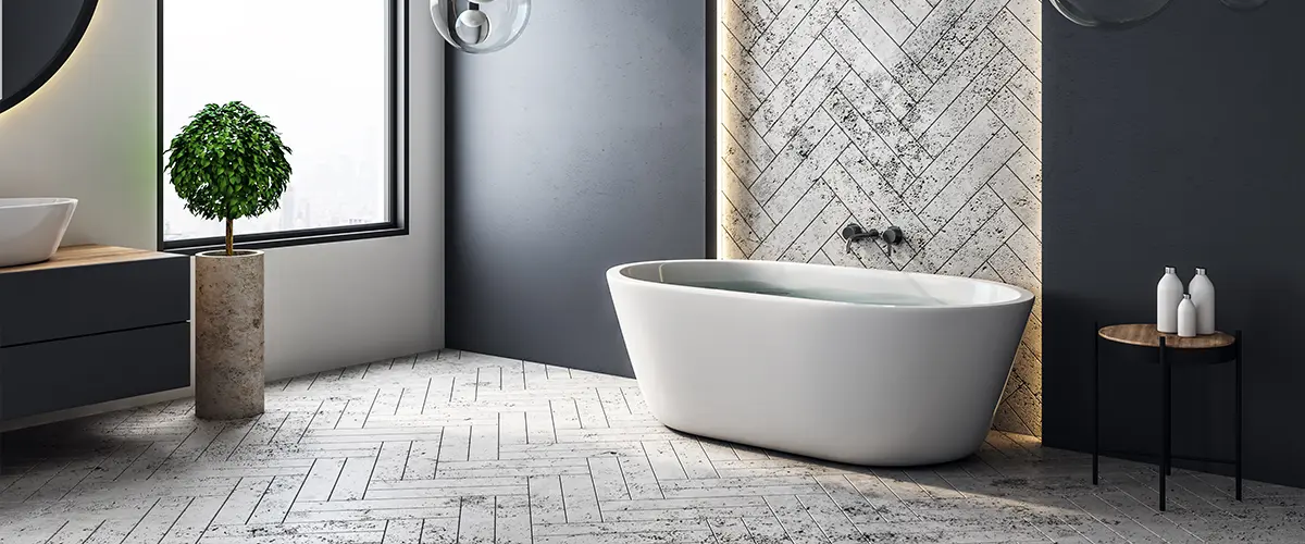 Modern bathroom in grey and black tones with tub and big window.